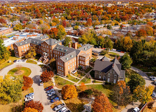 An aerial view of a campus with a large building in the center.