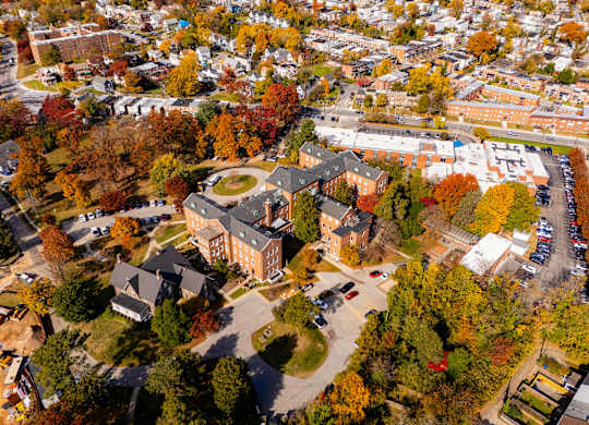An aerial view of a campus with a large building in the center.