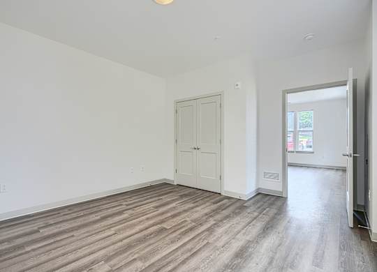 A room with a white door and a window.