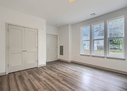 A room with a wooden floor and white walls.