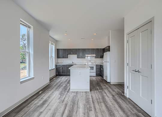 A kitchen with a white island in the middle of the room.
