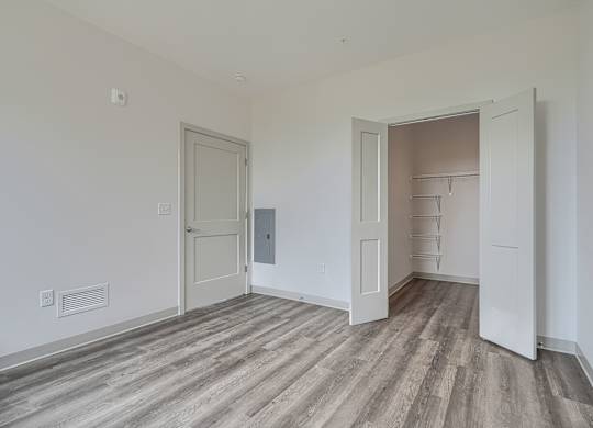 A room with a wooden floor and white walls.