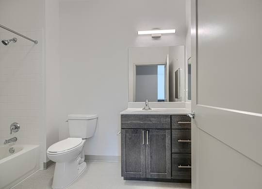 A white toilet sits next to a sink in a bathroom.