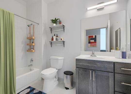 A bathroom with a white toilet, a white sink, and a green shower curtain.
