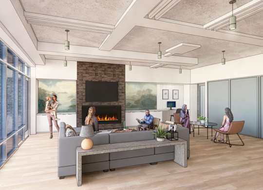A group of people are sitting around a fireplace in a modern living room.