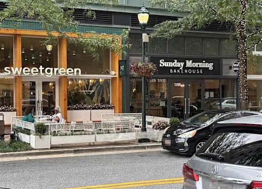 A street view of a Sweetgreen and Sunday Morning bakery.
