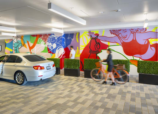 a car is parked in a lobby with a mural