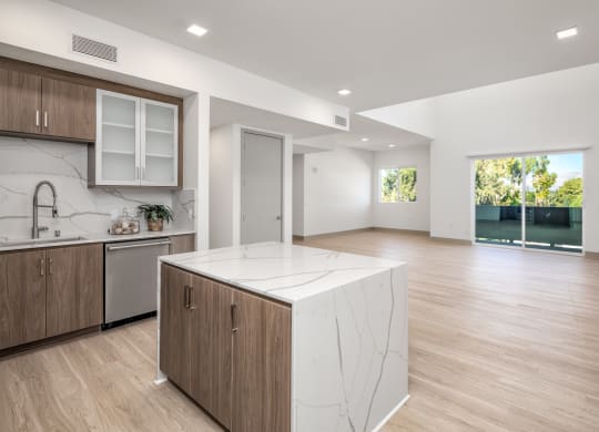 a large kitchen with a marble island in the middle of it