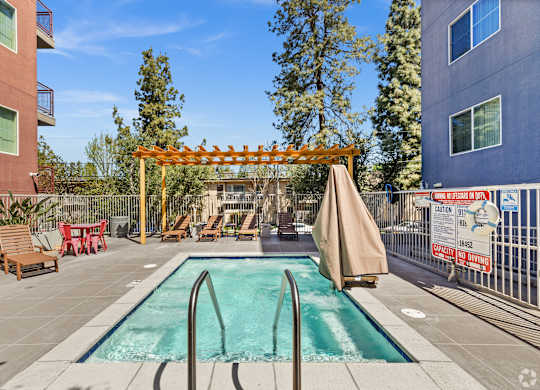 A pool area with a slide and sun loungers.