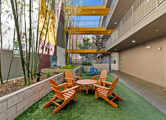 A patio with a table and chairs.
