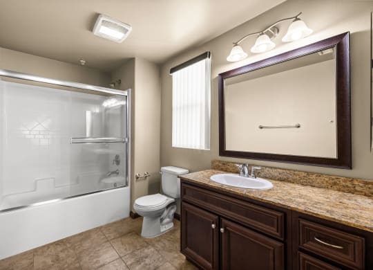 a bathroom with a shower toilet and sink and a mirror at Le Blanc Apartment Homes, California