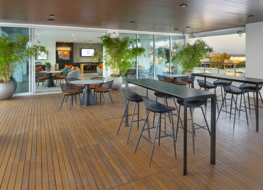a cafeteria with tables and chairs on a wooden floor
