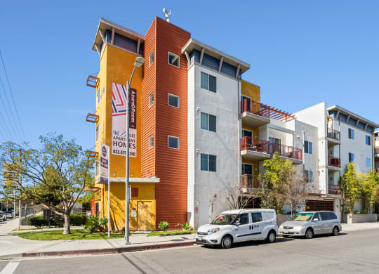 a new apartment building with cars parked in front of it