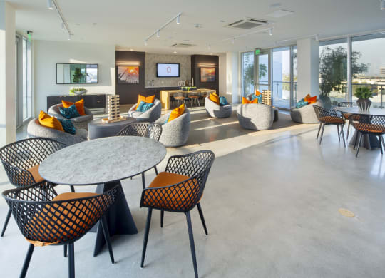 the lobby of an office building with tables and chairs
