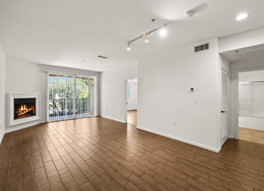 a living room with a fireplace and a wooden floor at Le Blanc Apartment Homes, Canoga Park, California