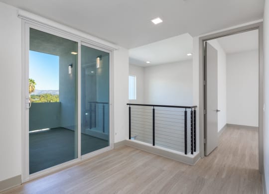 a large glass door leading to a balcony in a house