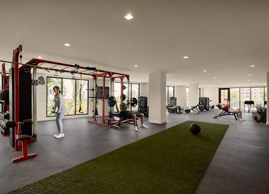 A woman is working out in a gym with a variety of equipment.