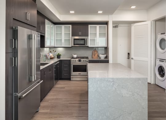 a kitchen with stainless steel appliances and white counter tops