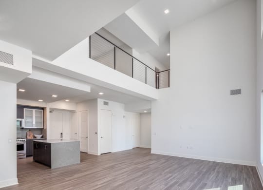 the living room and kitchen in a new home with white walls and ceilings