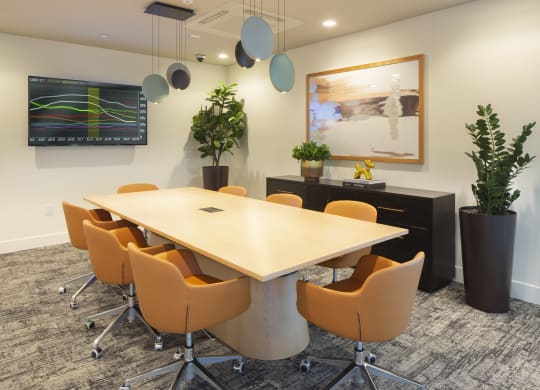 an empty conference room with a table and chairs
