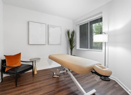 an office with a white table and chair and a window