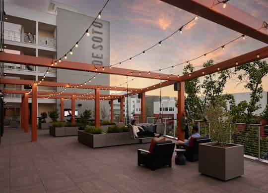 A Desoto sign is hanging from a pergola on a patio.