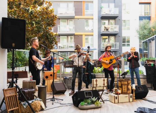 a group of musicians playing instruments on a stage