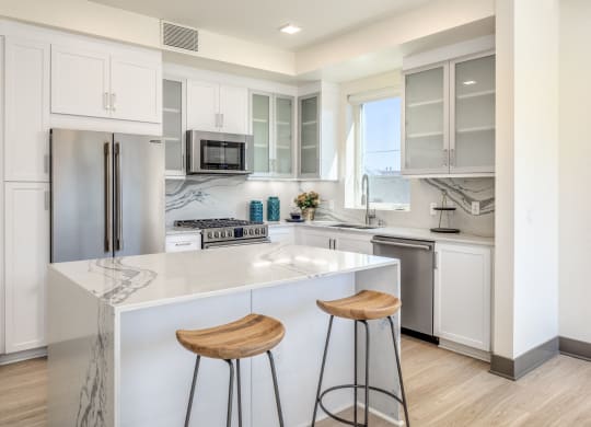 a kitchen with a counter and two stools