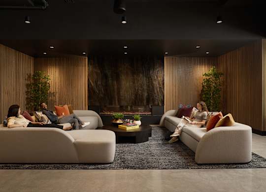 A modern living room with a large couch and a coffee table.