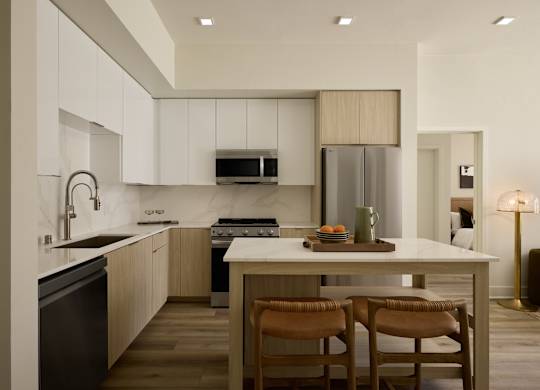 A modern kitchen with a dining table and chairs.