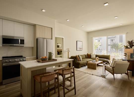 A modern kitchen with a dining area and a living room.