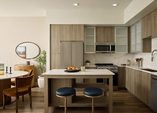 A modern kitchen with a dining table and chairs.