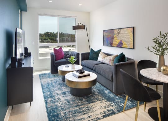 Two-Bedroom Apartments in Woodland Hills, CA - The Q Variel - Living Room with Luxury Vinyl Flooring, High Ceilings, Oversized Windows, and Access to the Dining Area and Kitchen