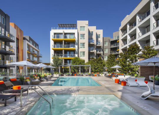 a rendering of a pool in front of an apartment building