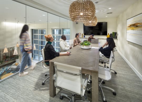a group of people sitting around a table in an office