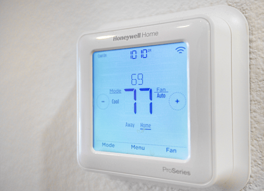 A Honeywell Home Pro Series thermostat shows the temperature is 77 degrees.