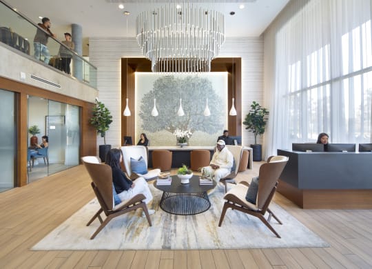 a rendering of a hotel lobby with a large chandelier and people in the background