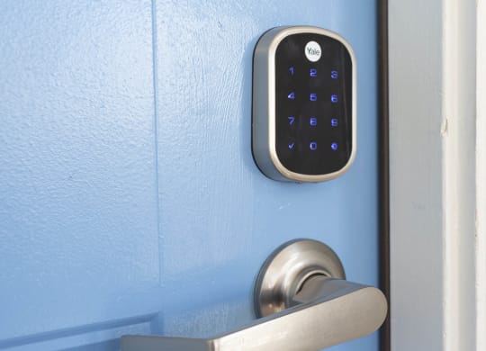 an open door with a digital lock on the door handle at Le Blanc Apartment Homes, Canoga Park, California
