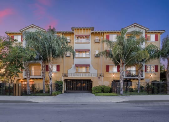 a street view of an apartment building with palm trees at Dronfield Astoria, 13140 Dronfield Ave