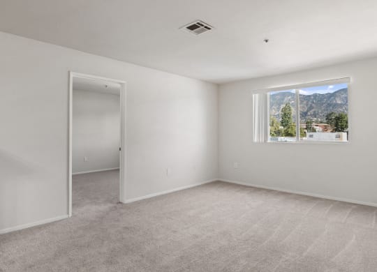 an empty room with white walls and a window with a mountain view at Dronfield Astoria California, 91342