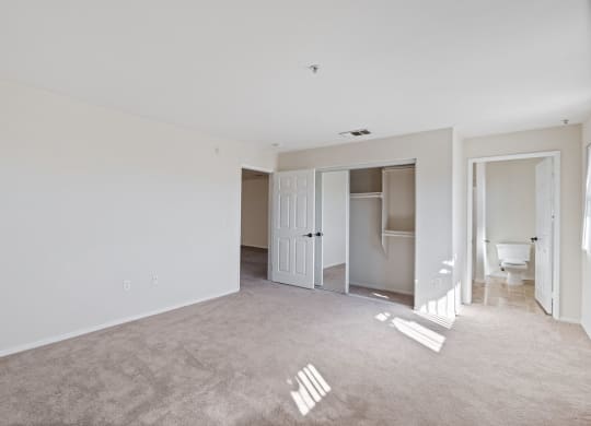 an empty living room with white walls and a bathroom at Dronfield Astoria, Sylmar, California