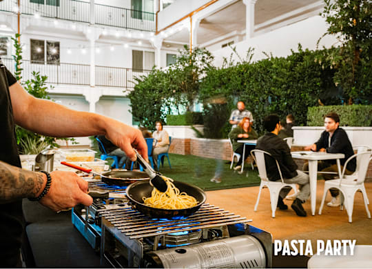 A man is cooking pasta for a pasta party.