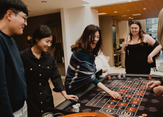 a group of people playing roulette at a table