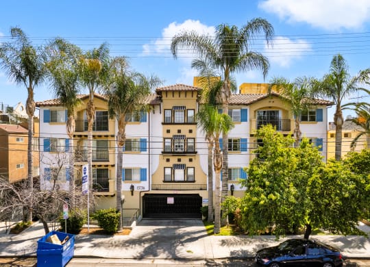 exterior image of a building with palm trees and blue sky at Toscana Apartments, Van Nuys