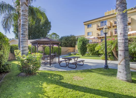 a backyard with a picnic table and a gazebo