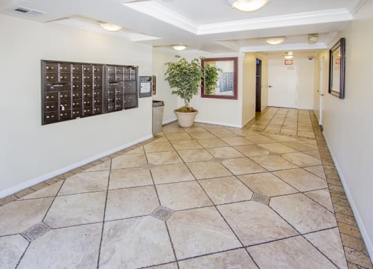 a hallway with tile floors and a calendar on the wall