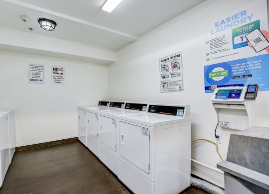 a laundry room with two washes and two washing machines