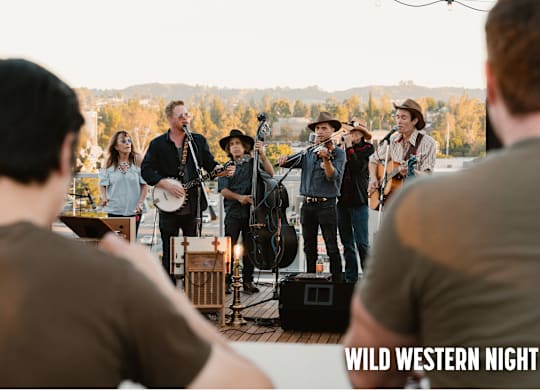 A group of people are playing music on a stage with the words