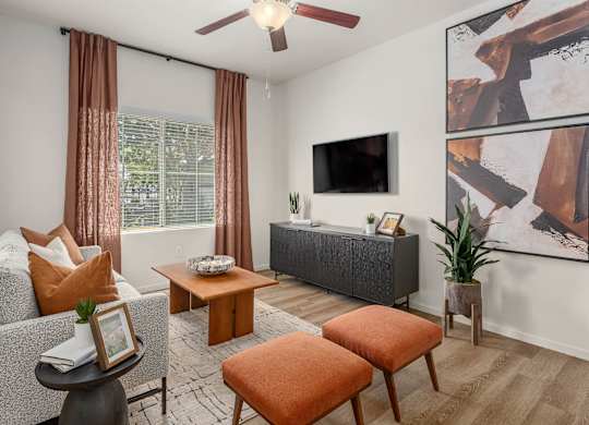 A living room with a grey sofa, a brown coffee table, and a grey couch.