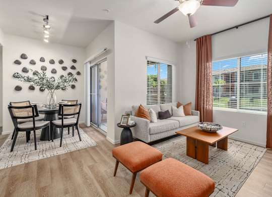A living room with a dining table and chairs.